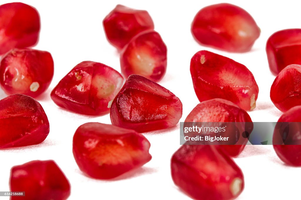 Ripe pomegranate seeds, isolated on white background