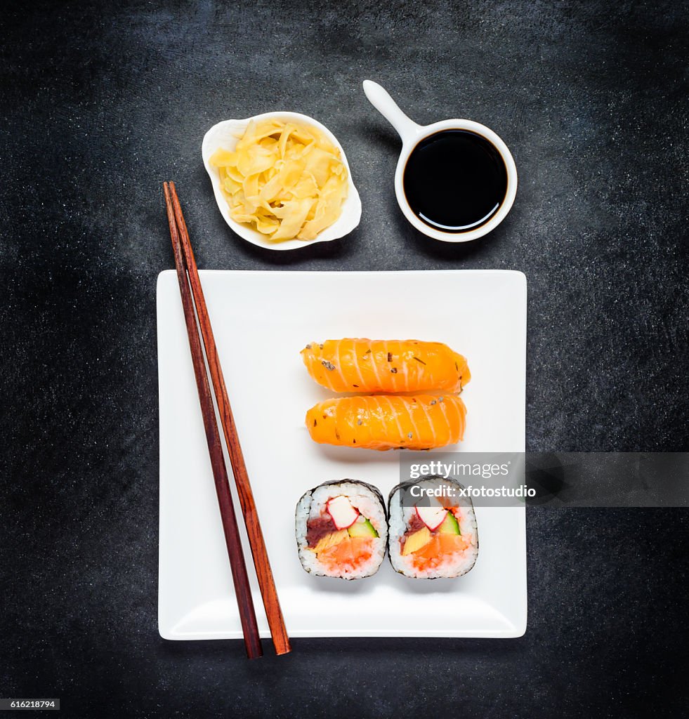 Sushi with Tsukemono and Soy Sauce on White Plate