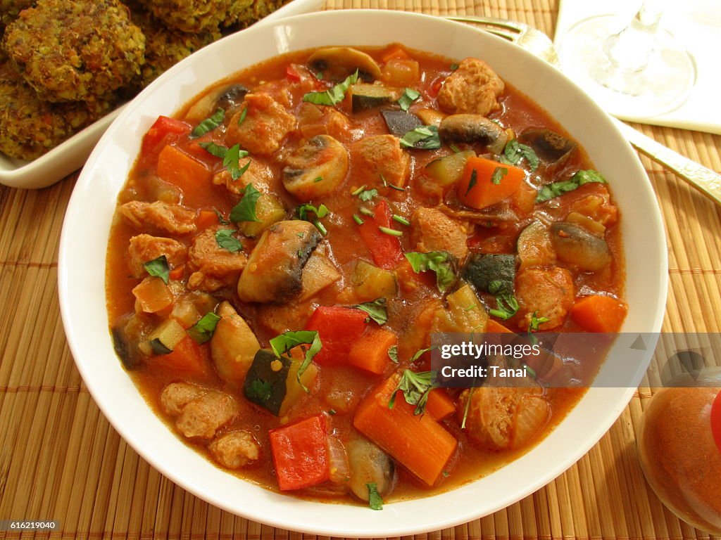 Stewed vegetables with soy and mushrooms in a white bowl