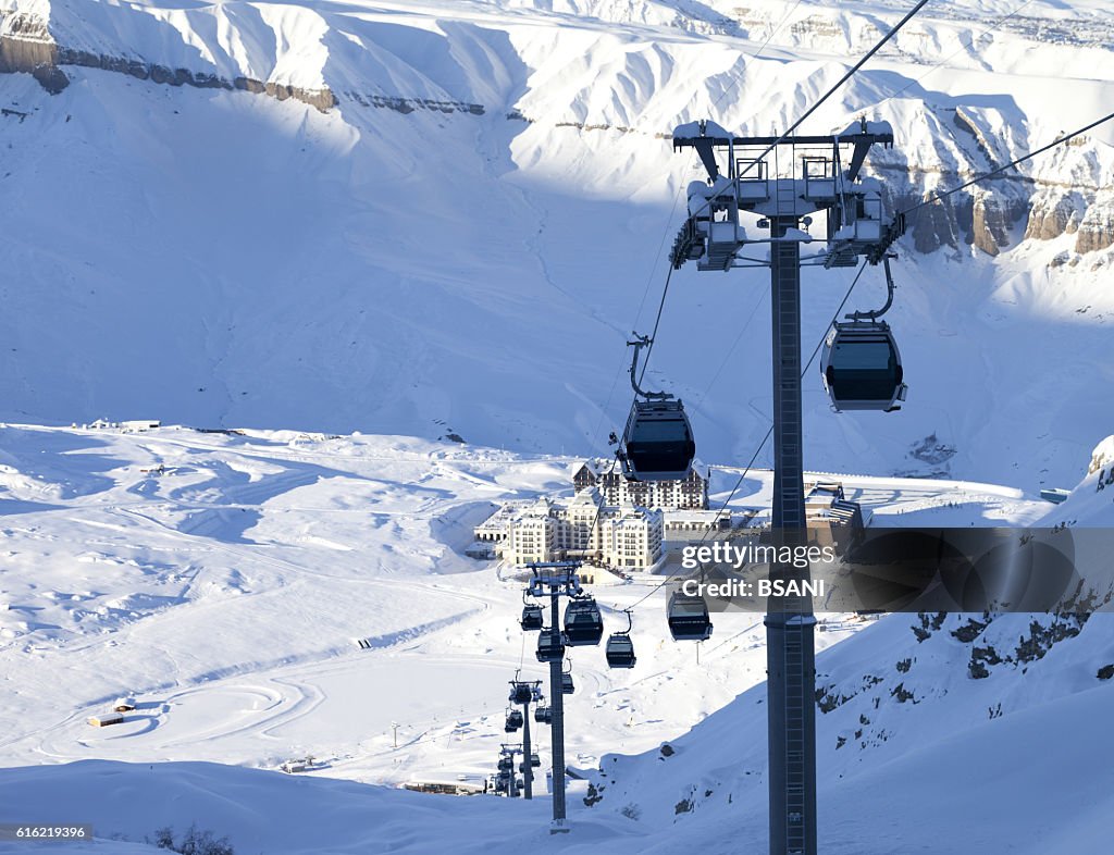 Gondola lift on ski resort at winter sun evening