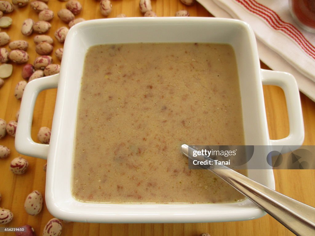 Bean soup in square bowl with spoon