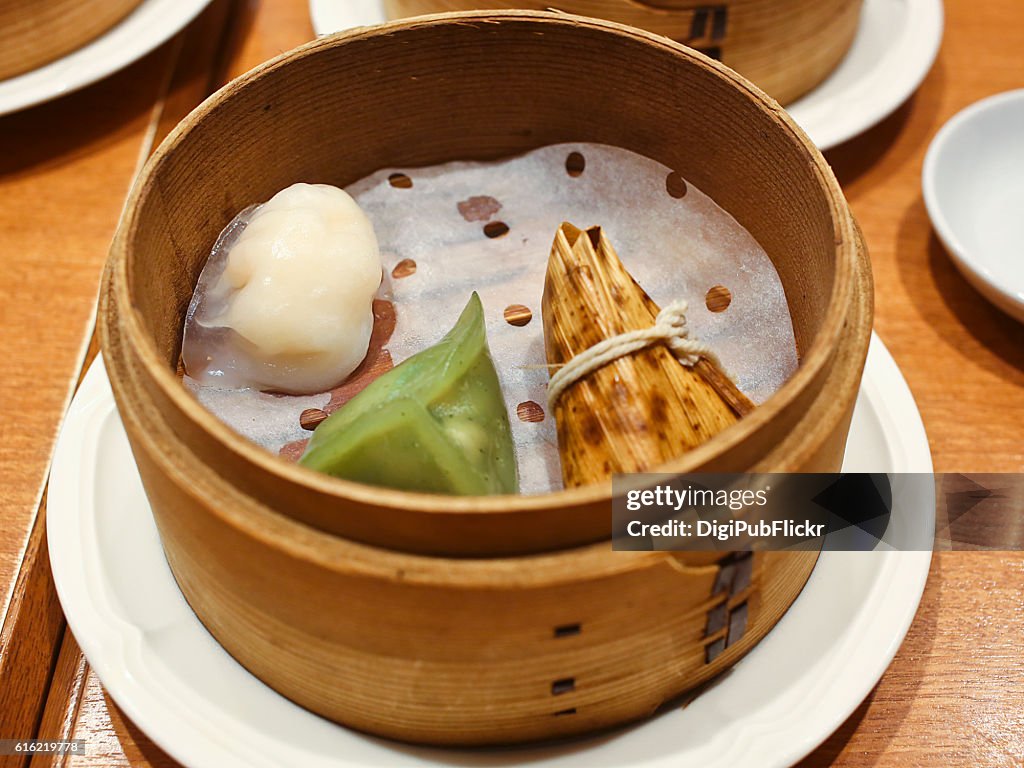 Chinese Dim Sum Served in Wood Steamer on Table