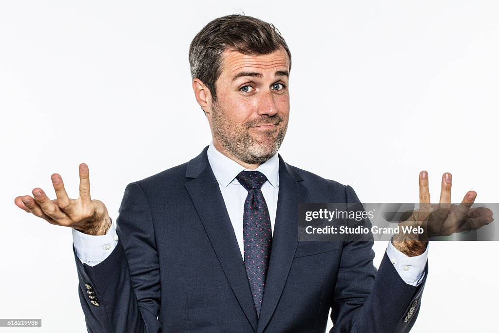 Happy handsome business man showing hands up for carefree success