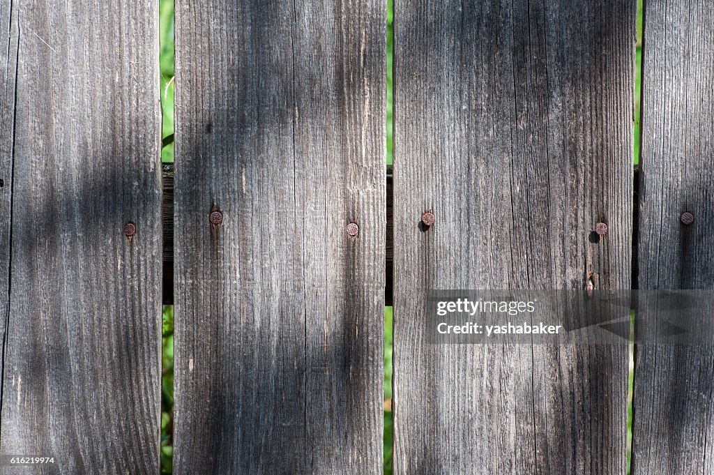 Grey wood  old planks texture background with sun and shadows