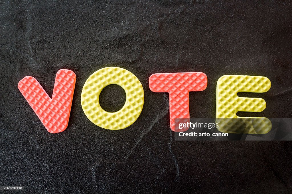 The word vote on black background