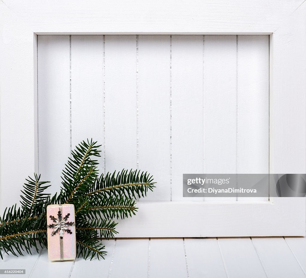 White wooden frame and  christmas decoration over white background