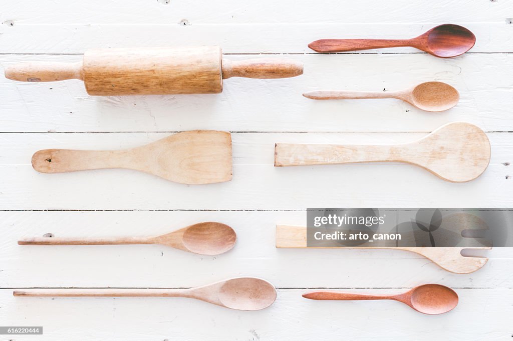 Wooden kitchen utensils on white  wooden background