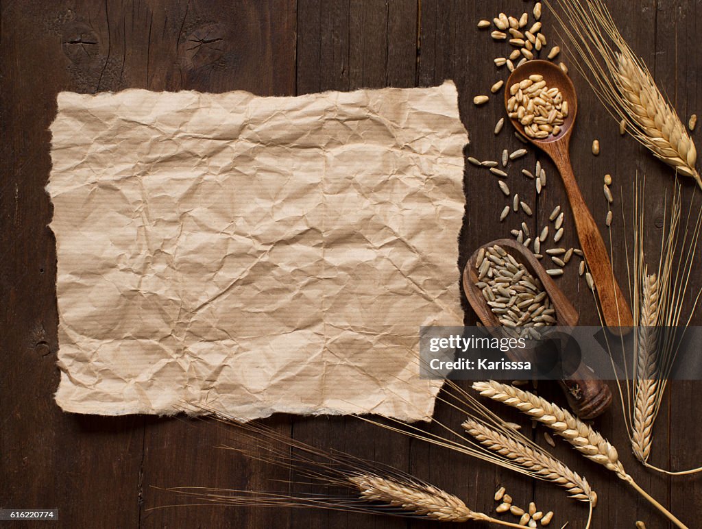 Wheat and spelt on wooden background