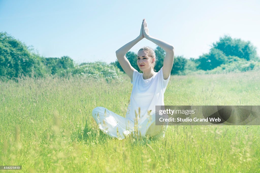 Smiling beautiful young yoga woman praying for toned spiritual mindfulness