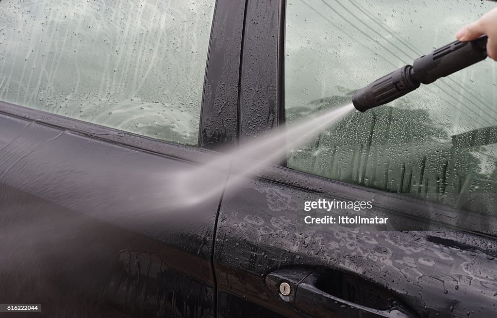 Car Washing. Cleaning Car Using High Pressure Water