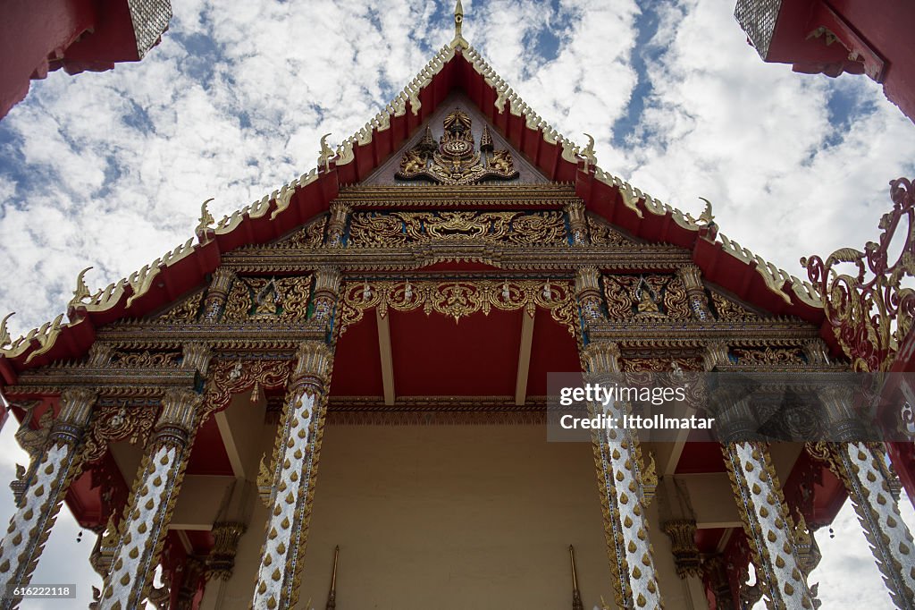 Thai temple with blue sky and clouds in background