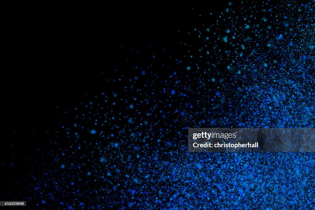 Colourful abstract powder explosion on a black background