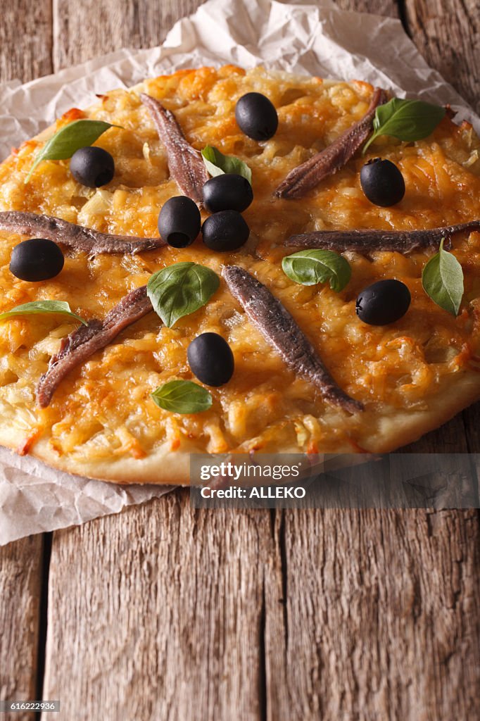 Pizza with anchovies, olives and onion close-up. Vertical