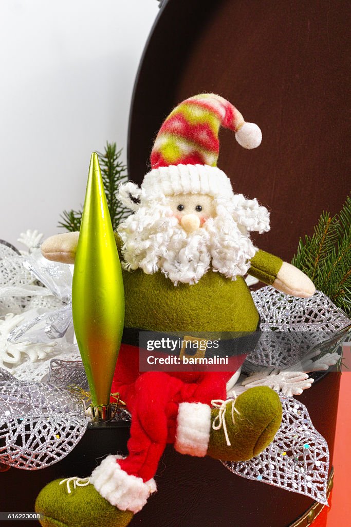 Santa Claus sits on vintage brown coffer