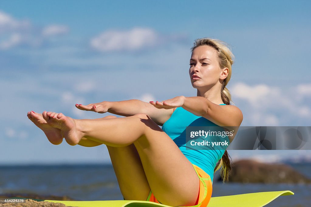 Young caucasian fitness woman practicing yoga