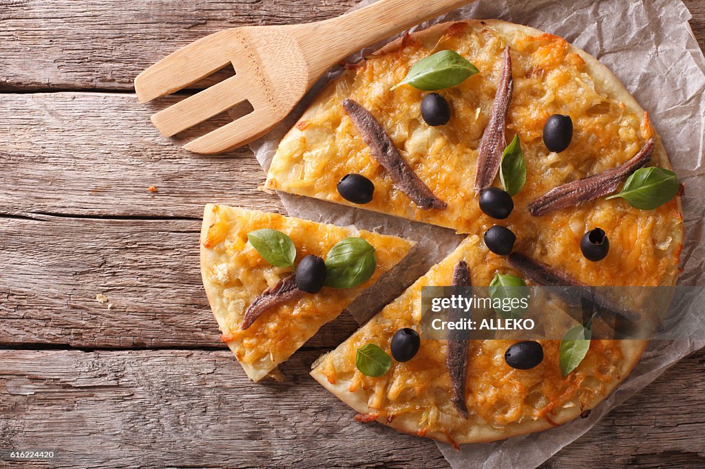 Sliced pizza with anchovies and onions. Horizontal top view
