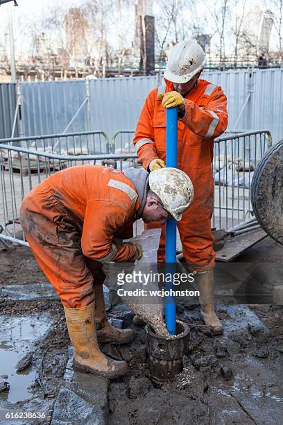 men work on a borehole - borehole stock pictures, royalty-free photos & images