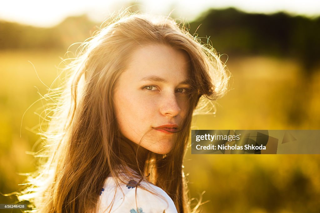 Beautiful girl the flowers field woman the flowers field sunset