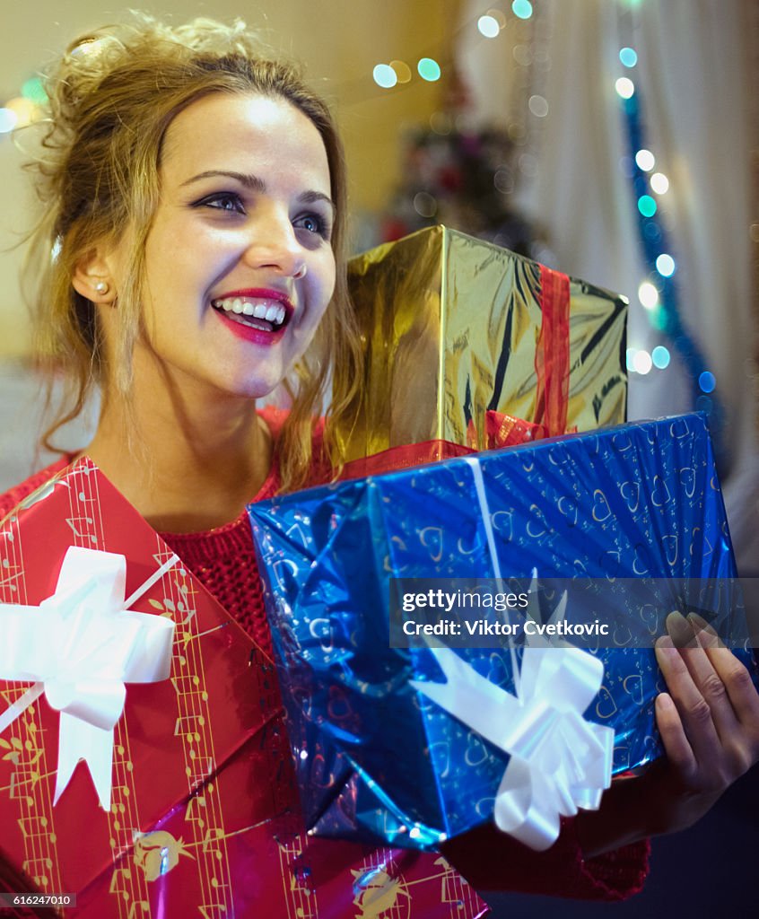 Pretty young woman with gifts.