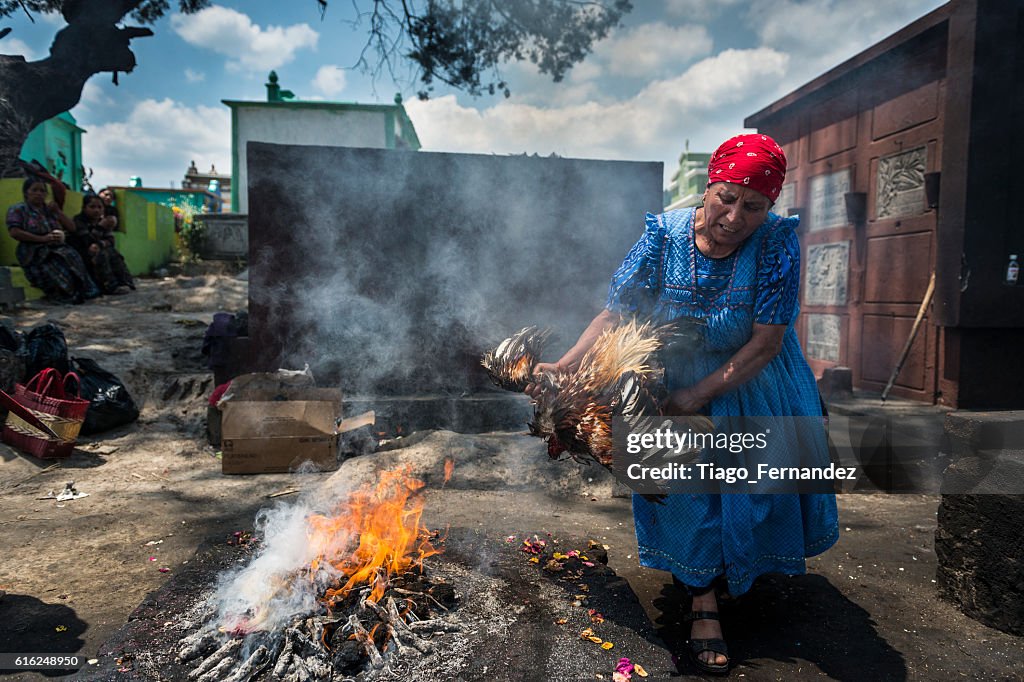 Maya woman performing a ritual in the cemetery of Chichicastenango