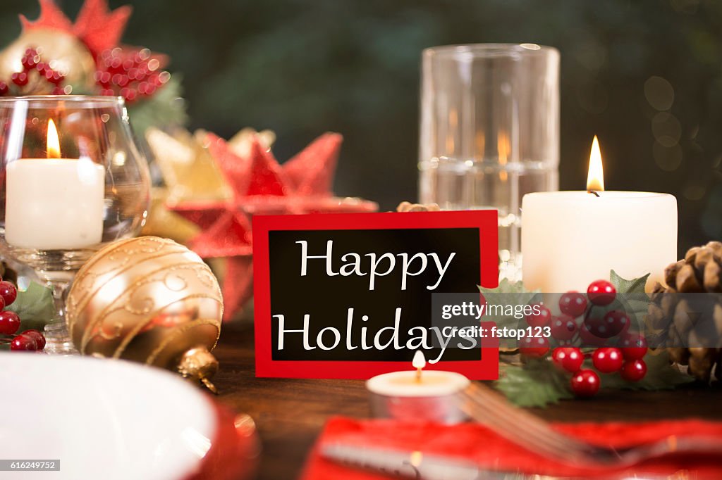 Dining table place setting with Christmas decorations.