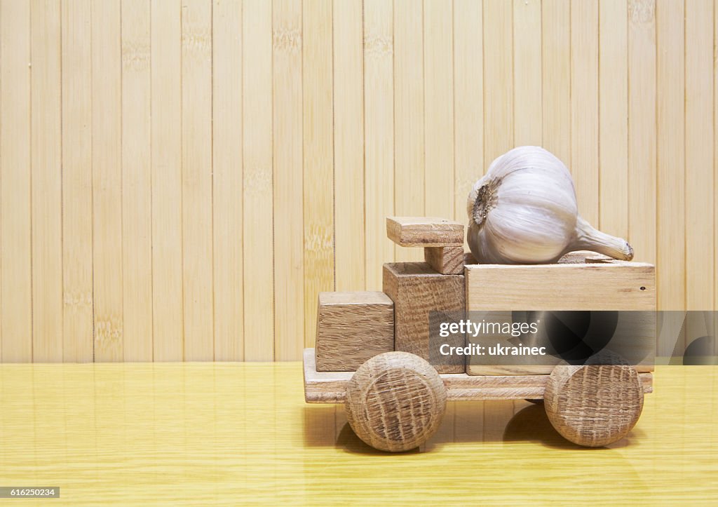 Toy wooden car with garlic