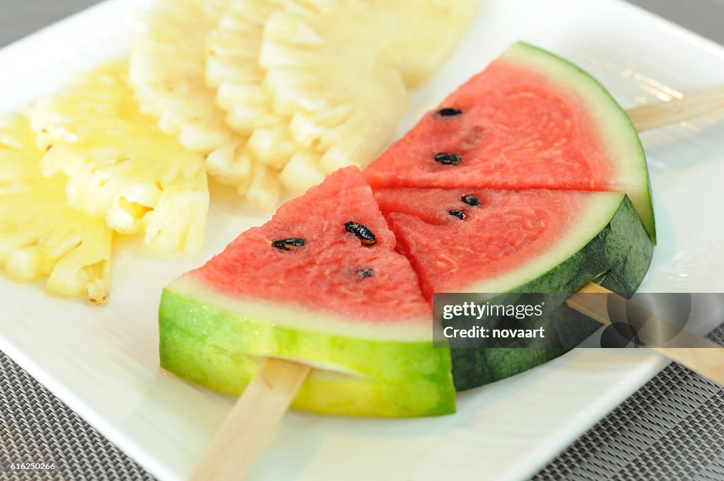 Pineapple slices with watermelon sticks