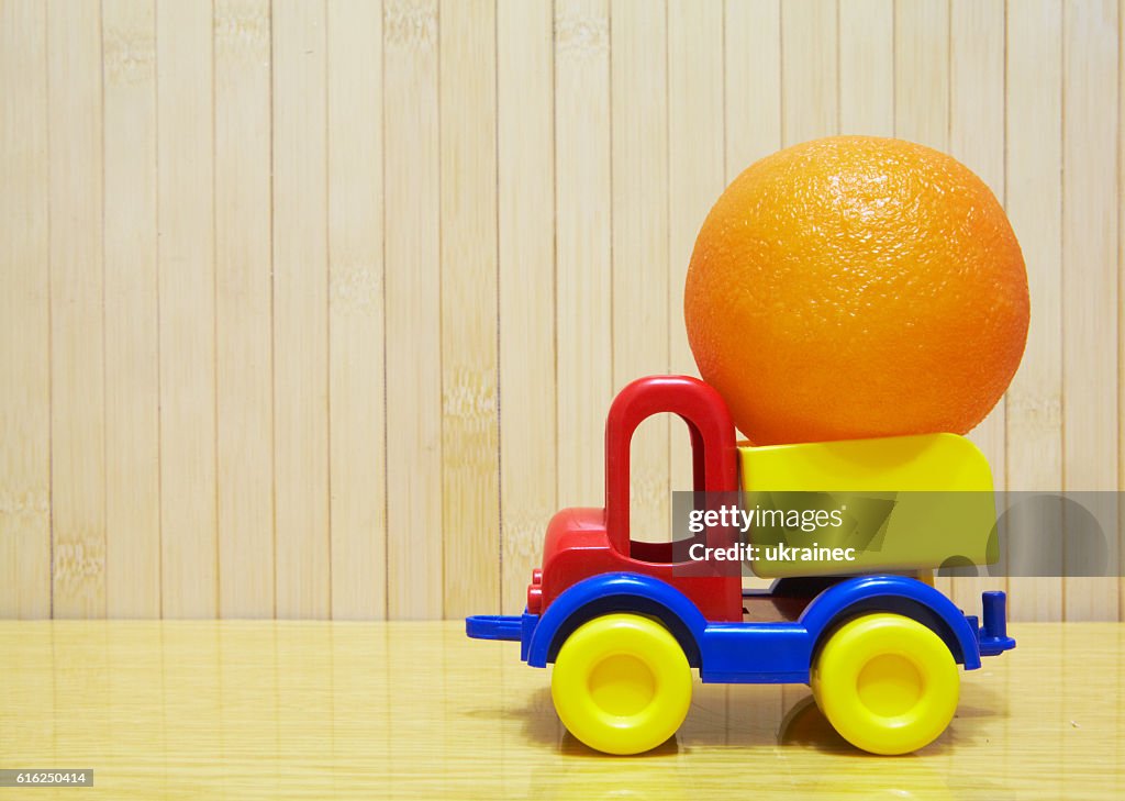 Toy plastic car with orange