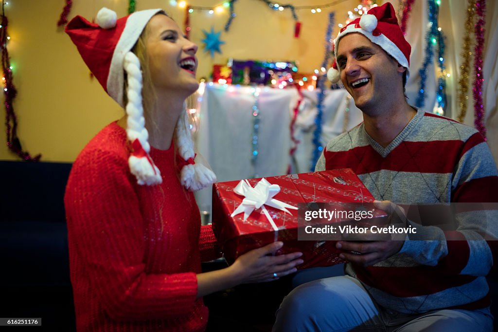 New Year. Christmas portrait of relaxed couple with gifts.
