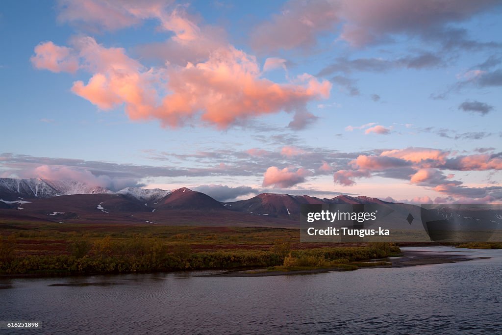 Red clouds at sunrise over the river.