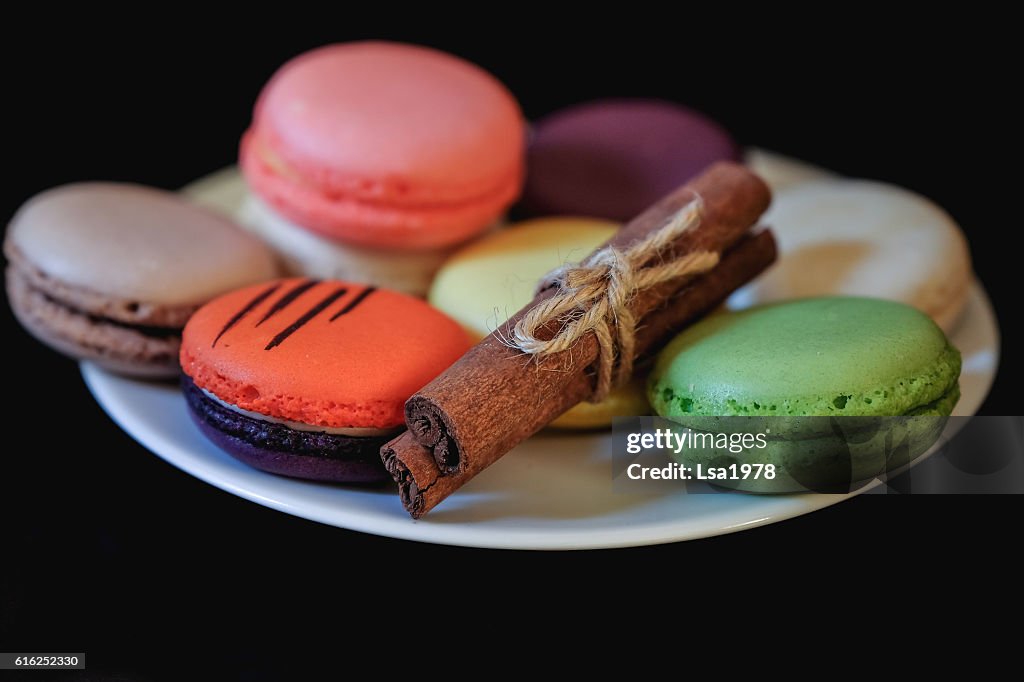 Different colored macaroons on white plate