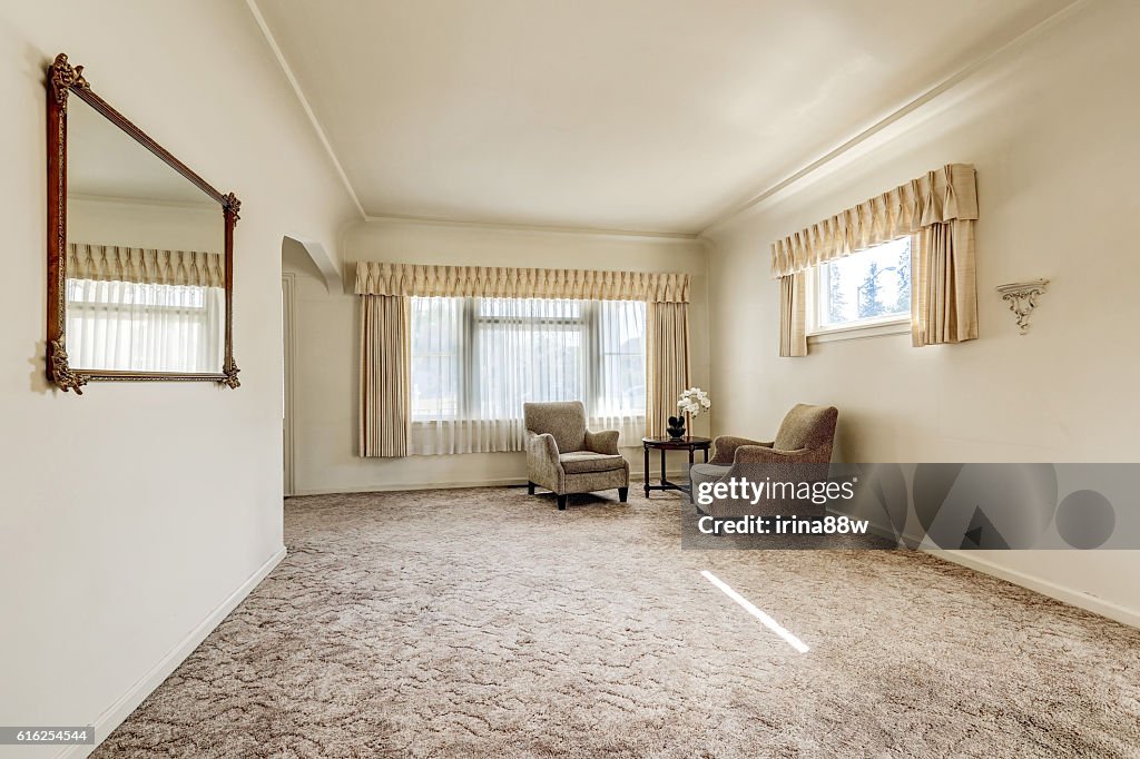 Spacious sitting room in creamy colors.