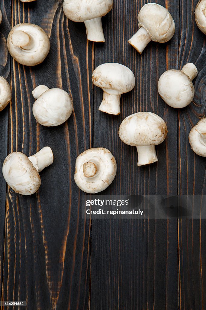 Champignon mushroom on wooden background