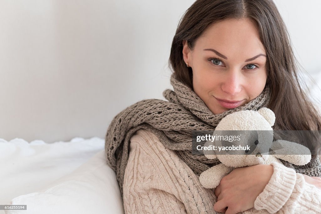 Joyful positive woman hugging a teddy bear