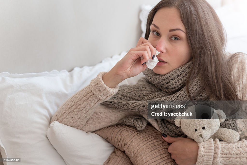 Cheerless young woman suffering from flu