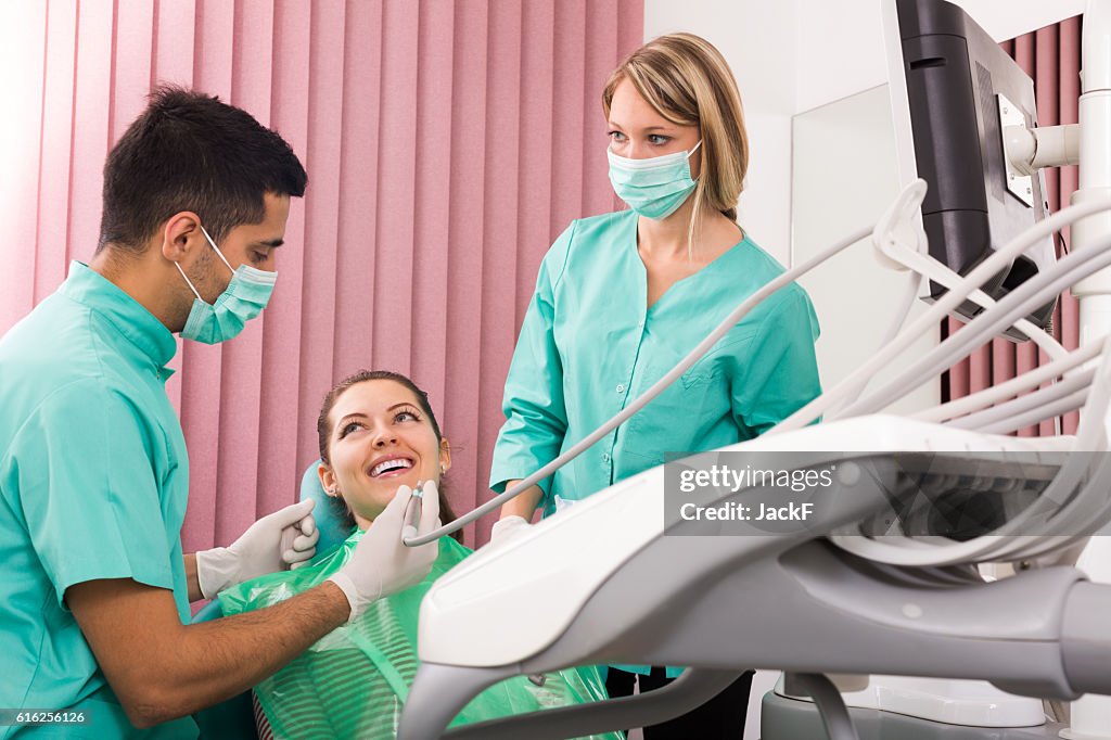 Portrait of dentist and patient at dental clinic