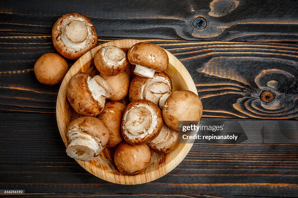 Champignon mushroom on wooden background