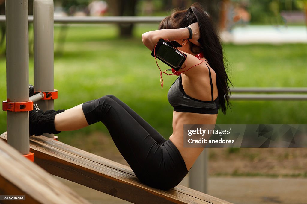 Fitness woman doing sit-ups exercising for her abdominal muscles