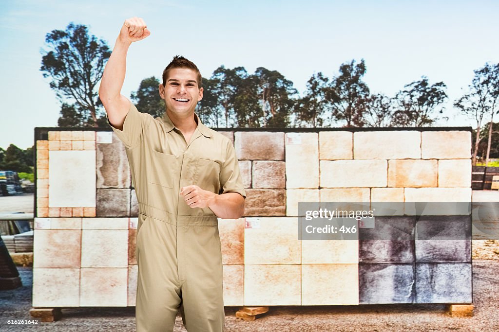 Smiling worker cheering outdoors