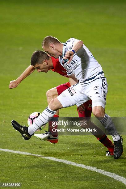 Besart Berisha of the Victory competes for the ball with Iacopo La Rocca of Adelaide United during the round three A-League match between Adelaide...