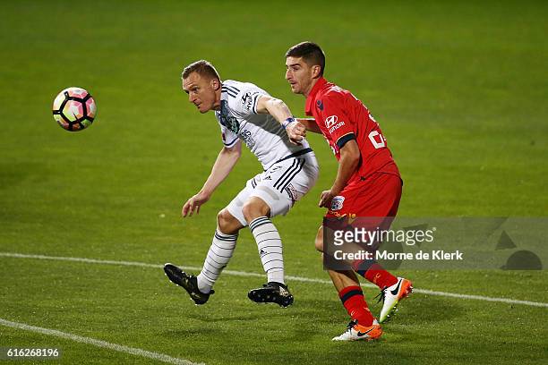 Besart Berisha of the Victory competes for the ball with Iacopo La Rocca of Adelaide United during the round three A-League match between Adelaide...