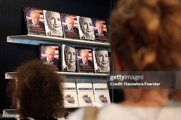 Books about Donald Trump and Hilary Clinton are displayed on the Plassen stand at the 2016 Frankfurt Book Fair on October 22, 2016 in Frankfurt am...