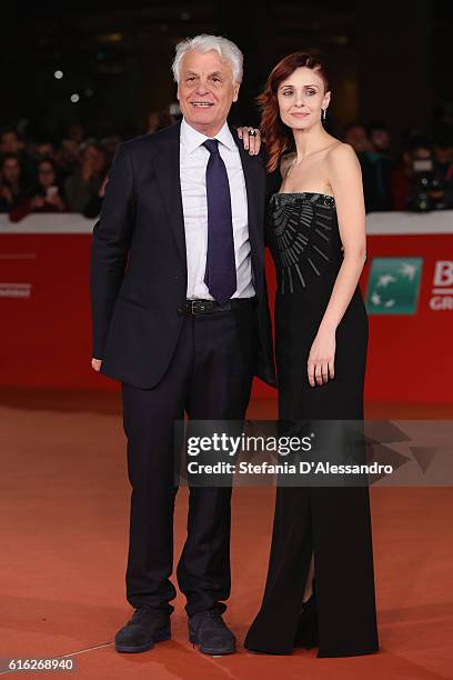 Michele Placido and Federica Vincenti walk a red carpet for '7 Minuti' during the 11th Rome Film Festival at Auditorium Parco Della Musica on October...