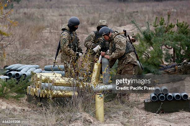 Ukrainian serviceman cleans shells as they fire a 152mm 'Msta B' howitzer during a military exercises on the Devichki shooting range, about 85 km of...