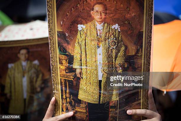 Mourners dressed in black gathers around the Grand Palace as they attends to perform the Royal Anthem at Sanam Luang in Bangkok, Thailand on October...