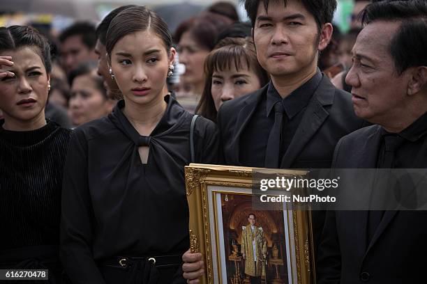 Mourners dressed in black gathers around the Grand Palace as they attends to perform the Royal Anthem at Sanam Luang in Bangkok, Thailand on October...