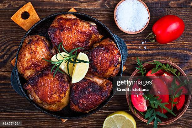 homemade roasted chicken thighs  in cast iron pan for dinner, top view - thigh stock pictures, royalty-free photos & images