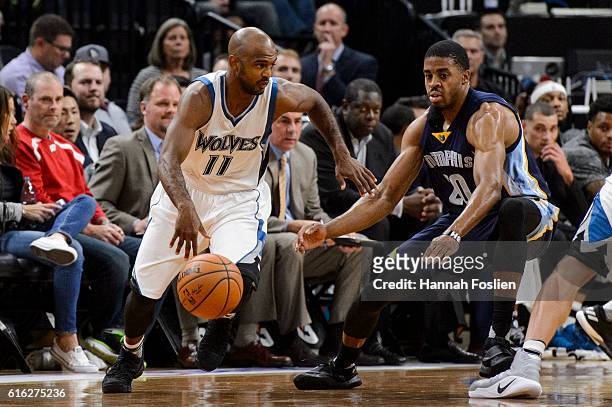 John Lucas III of the Minnesota Timberwolves dribbles the ball against D.J. Stephens of the Memphis Grizzlies during the preseason game on October...