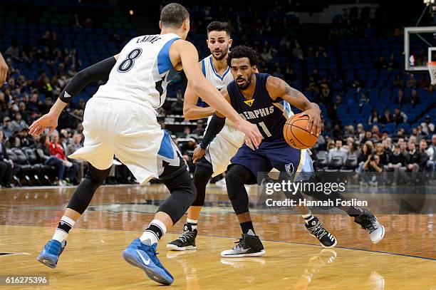 Zach LaVine and Ricky Rubio of the Minnesota Timberwolves guards against Mike Conley of the Memphis Grizzlies during the preseason game on October...