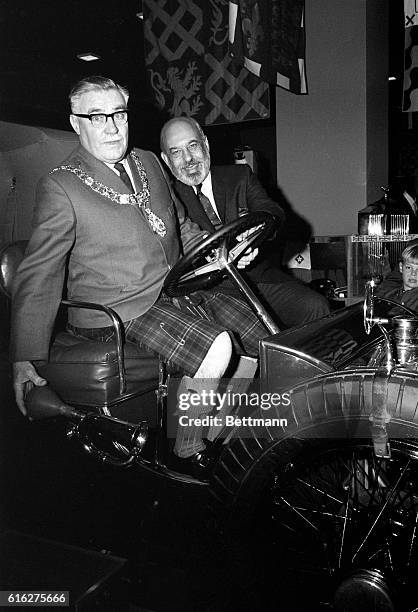 The Lord Provost of Edinburgh, Scotland, Herbert Brechin, and Neiman Marcus specialty store president, Stanley Marcus, , sit in a 1911 Rolls Royce...